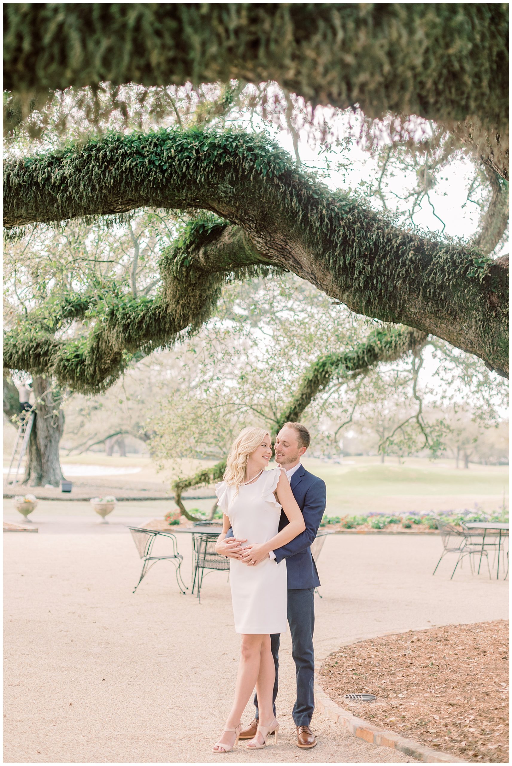 Katie and Harris snuggle under oak tree in New Orleans